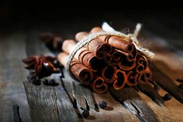 Cinnamon on dark wooden background, close-up