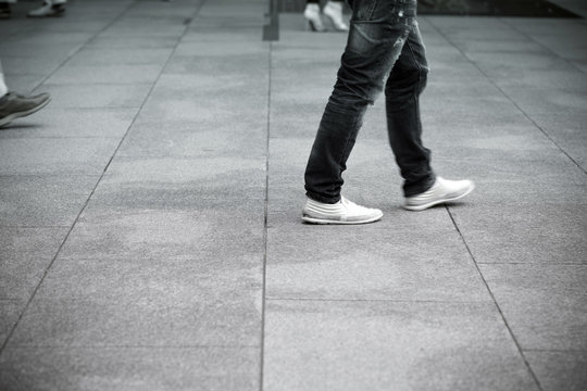 Men Walking On The Pavement