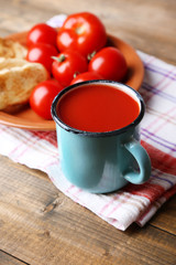 Homemade tomato juice in color mug, toasts and fresh tomatoes