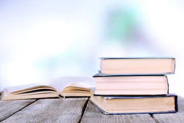 Books on wooden table on natural background