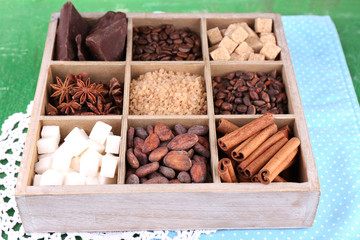 Wooden box with set of coffee and cocoa beans, sugar cubes,