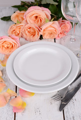 Table setting with pink rose on plate