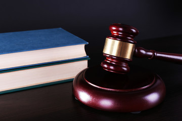 Judge's gavel and books on dark grey background