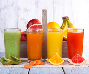 Fruit and vegetable juice in glasses and fresh fruits in box