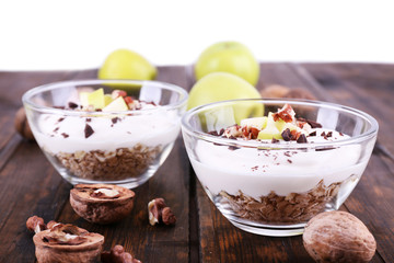 Oatmeal with yogurt in bowls, apples and walnuts