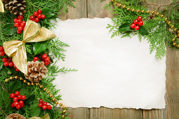 Christmas decoration with paper shit on wooden background