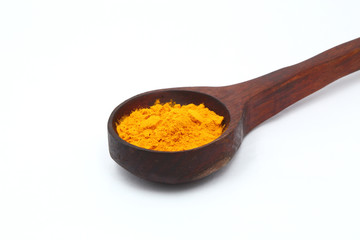 turmeric powder with wooden spoon