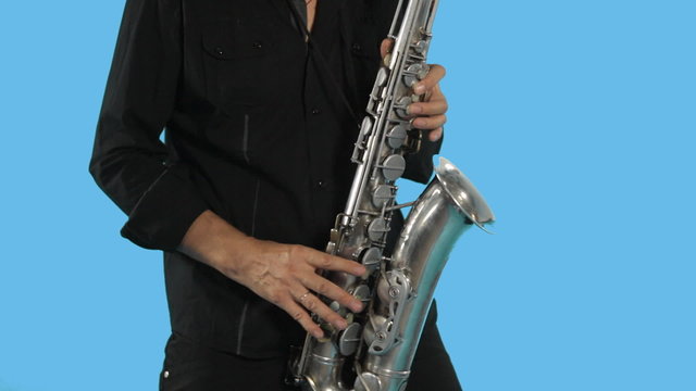 Talented saxophonist plays on his musical instrument and moves