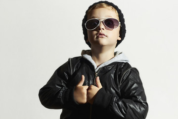 Obraz premium Fashionable funny child in sunglasses.Boy in Black cap