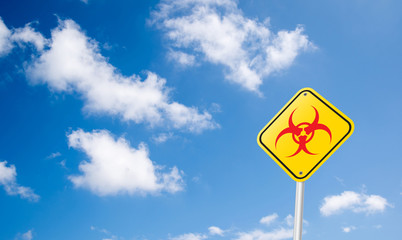 red Biohazard or Bio Hazard symbol Road Sign on blue sky