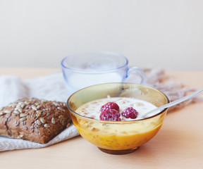 Muesli with fresh raspberries and milk, typical Scandinavian bre