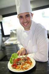 Portrait of young chef in restaurant