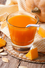 Delicious pumpkin juice with pulp in a glass
