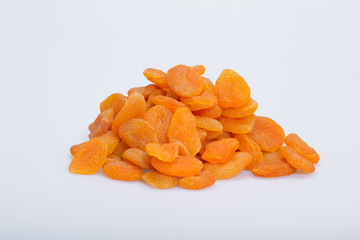 A heap of dried apricots on a white background