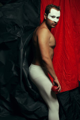 Backstage concept. Arty portrait of circus performer in white