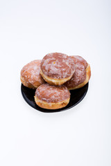 whole donuts on the black porcelain plate
