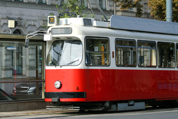 Plakat red tram carries passengers for European cities