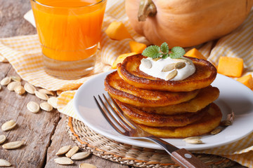 Pumpkin pancakes with sour cream and juice