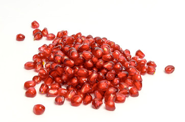 Scattered pomegranate seeds isolated on white background