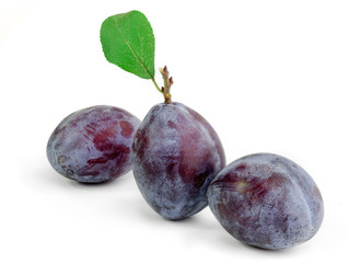 Group of plums with leaf isolated on a white background