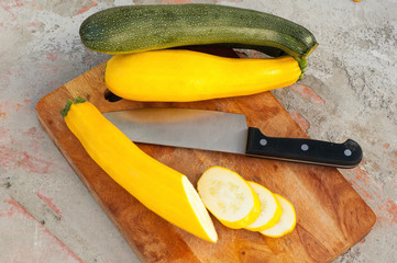Sliced zucchini on wooden cutting board