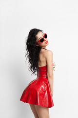 Sexy woman in red latex dress with sunglasses