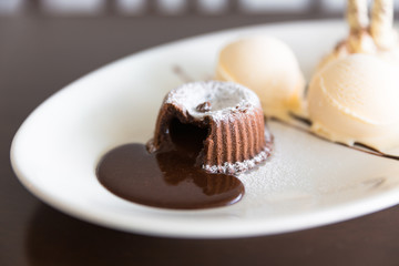 chocolate lava cake set with ice cream on white plate