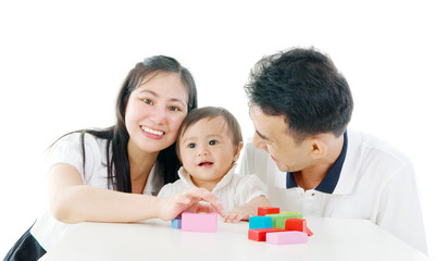 Obraz na płótnie Canvas Asian cute baby playing toys accompanied by parents