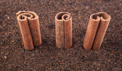 Cinnamon stick on dried and processed tea leaves
