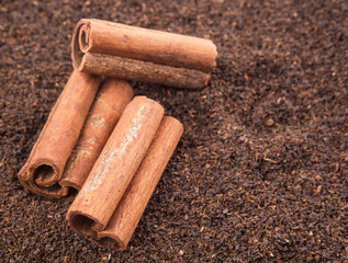 Cinnamon stick on dried and processed tea leaves