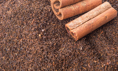 Cinnamon stick on dried and processed tea leaves