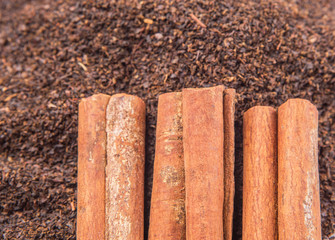 Cinnamon stick on dried and processed tea leaves