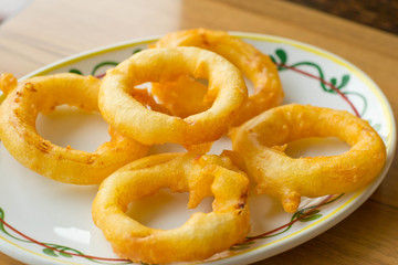 onion rings and dip sauce on the plate