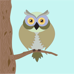 Fototapeta premium The wise old owl with yellow eyes , sitting lonely on the tree