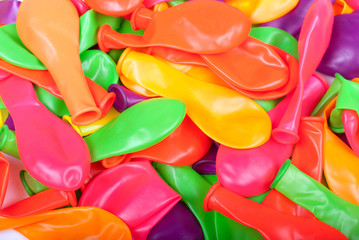 blow away a lot of colorful balloons