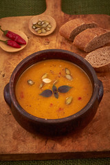 Bowl of pumpkin soup with bread