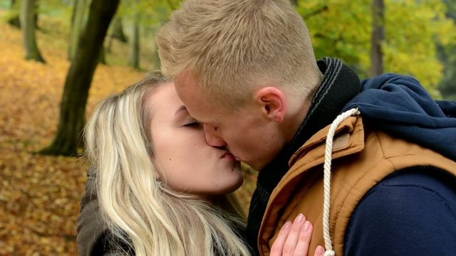 young model happy couple in love - couple kiss - autumn park