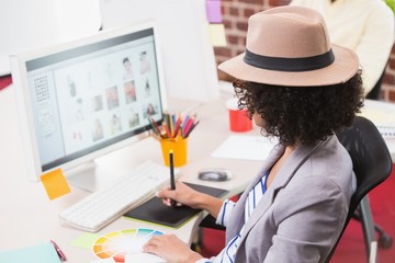 Female photo editor using digitizer in office