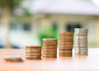 money coins stack like growing graph with home