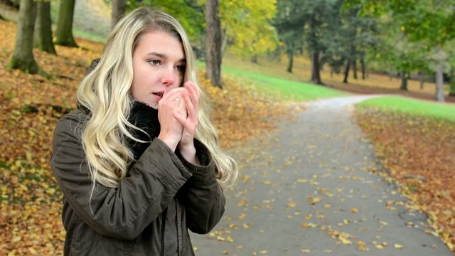 woman shivers with cold - autumn park-woman portrait