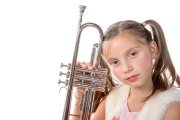 a pretty little girl with a trumpet look at the camera