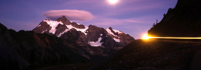 Lone Car Passes on Roadway Full Moon Mt Shuksan