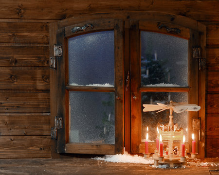 Lighted Red Candles on Stand at Window Pane