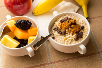 Fresh fruit and oatmeal with healthy toppings for breakfast