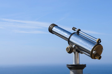 Touristic Metal Spyglass on the sky background