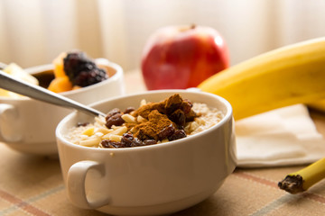 Fresh fruit and oatmeal with healthy toppings for breakfast