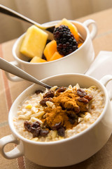 Fresh fruit and oatmeal with healthy toppings for breakfast