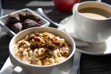 coffee and oatmeal with dried fruit  healthy breakfast setting