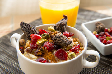 dried figs, oatmeal and orange juice breakfast setting