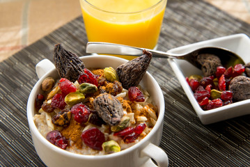 healthy breakfast oatmeal with dried  fruit and nut toppings